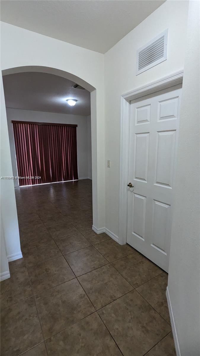 11840 Southwest 154th Avenue, Unit 11840 Miami, FL 33196 - Photo 11 of 61 an entryway of a hall with wooden floor