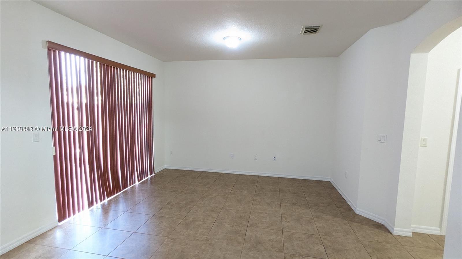 11840 Southwest 154th Avenue, Unit 11840 Miami, FL 33196 - Photo 16 of 61 an empty room with windows