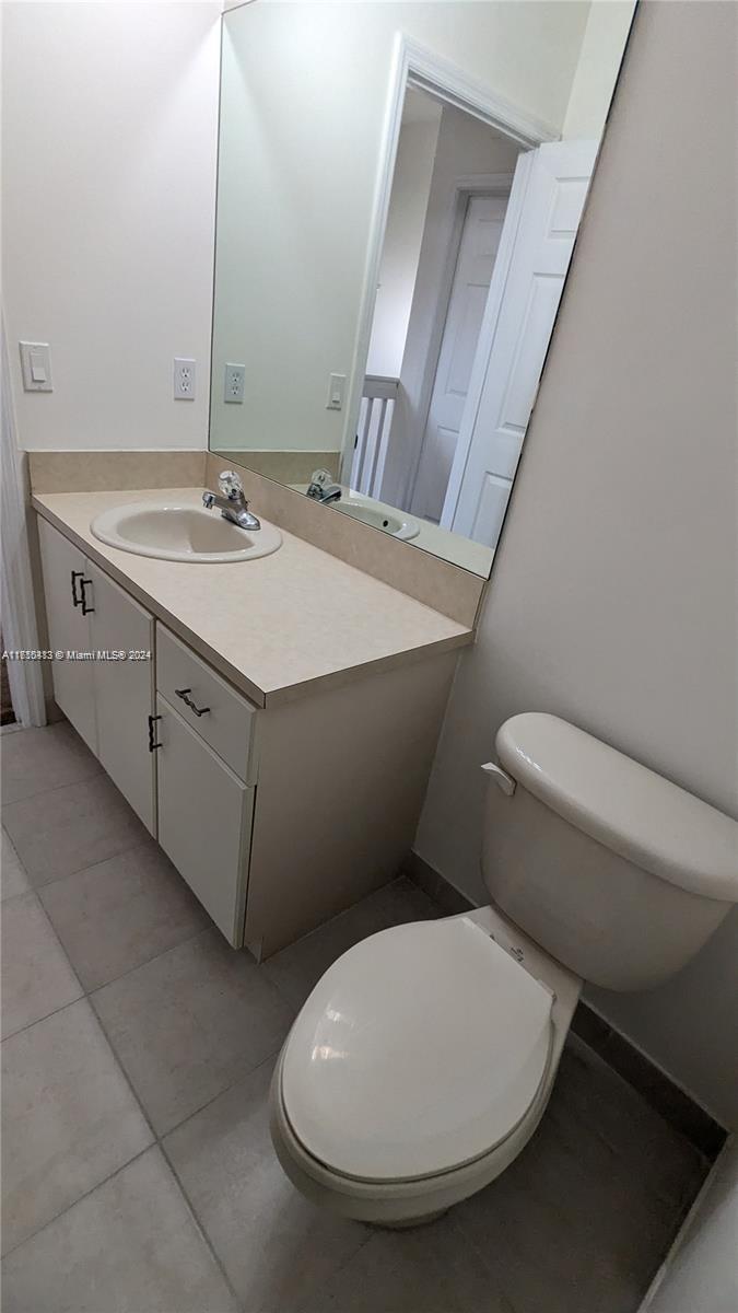 11840 Southwest 154th Avenue, Unit 11840 Miami, FL 33196 - Photo 35 of 61 a bathroom with a toilet sink and mirror
