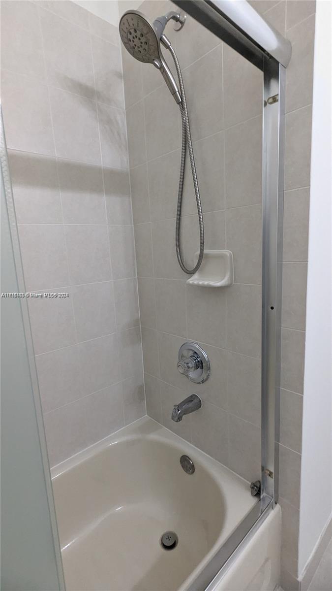 11840 Southwest 154th Avenue, Unit 11840 Miami, FL 33196 - Photo 37 of 61 a bathroom with a bath tub and a shower