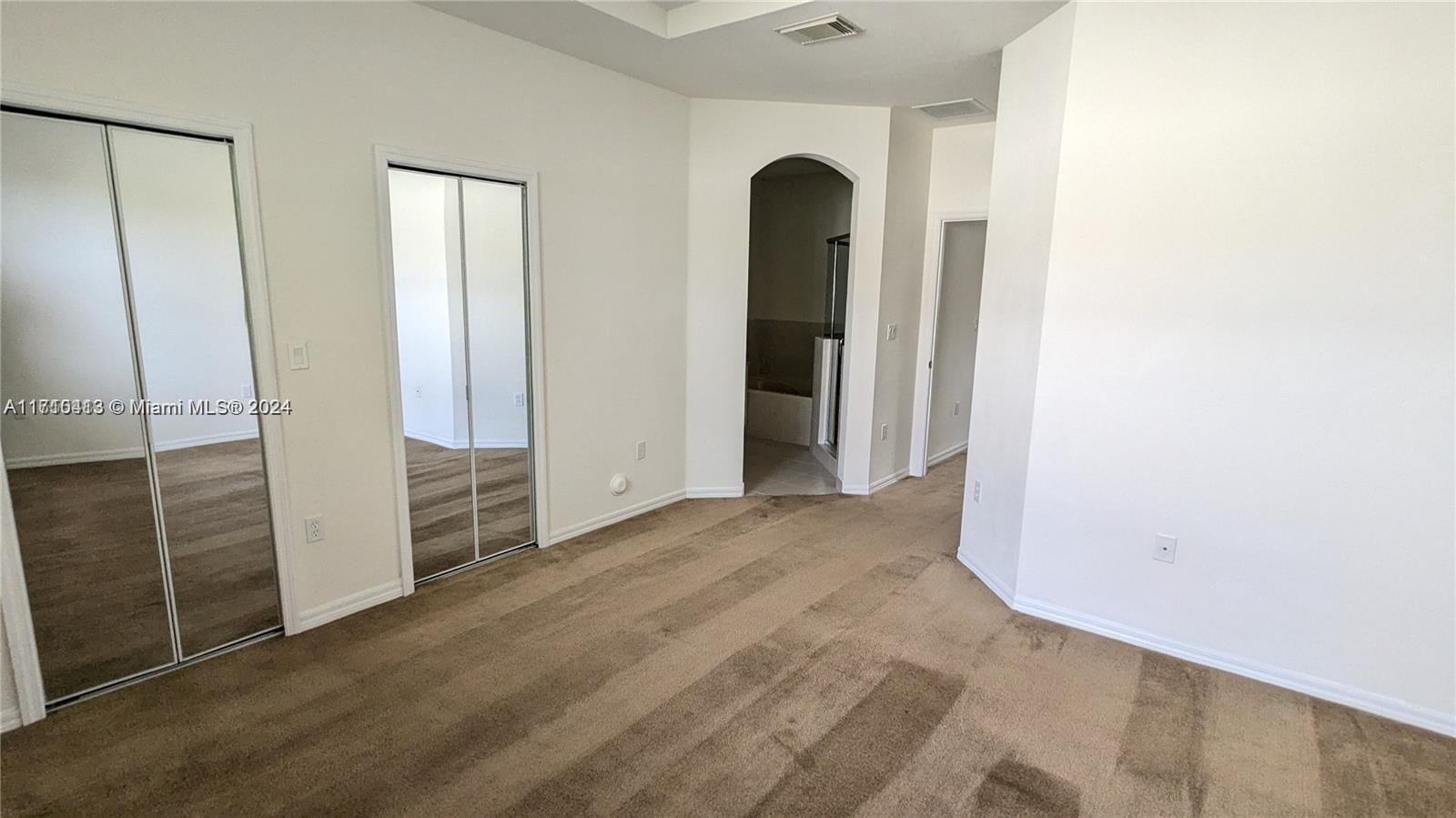 11840 Southwest 154th Avenue, Unit 11840 Miami, FL 33196 - Photo 48 of 61 an empty room with sliding door and wooden floor