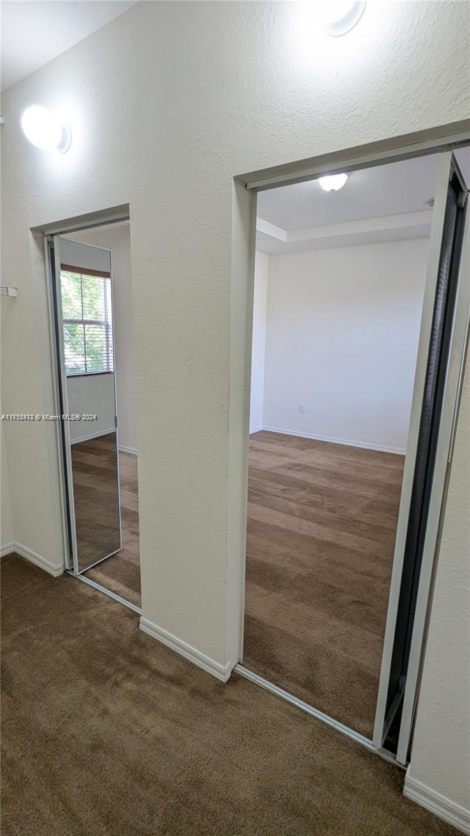 11840 Southwest 154th Avenue, Unit 11840 Miami, FL 33196 - Photo 49 of 61 an empty room with closet and mirror