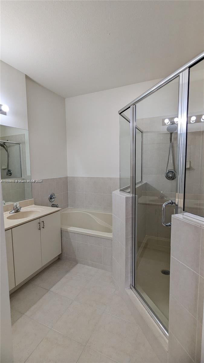 11840 Southwest 154th Avenue, Unit 11840 Miami, FL 33196 - Photo 51 of 61 a bathroom with a tub sink shower and mirror