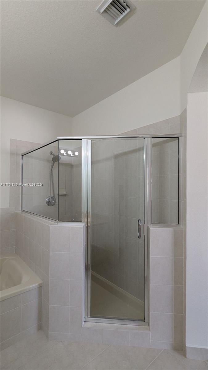 11840 Southwest 154th Avenue, Unit 11840 Miami, FL 33196 - Photo 52 of 61 a bathroom with a shower and a bath tub