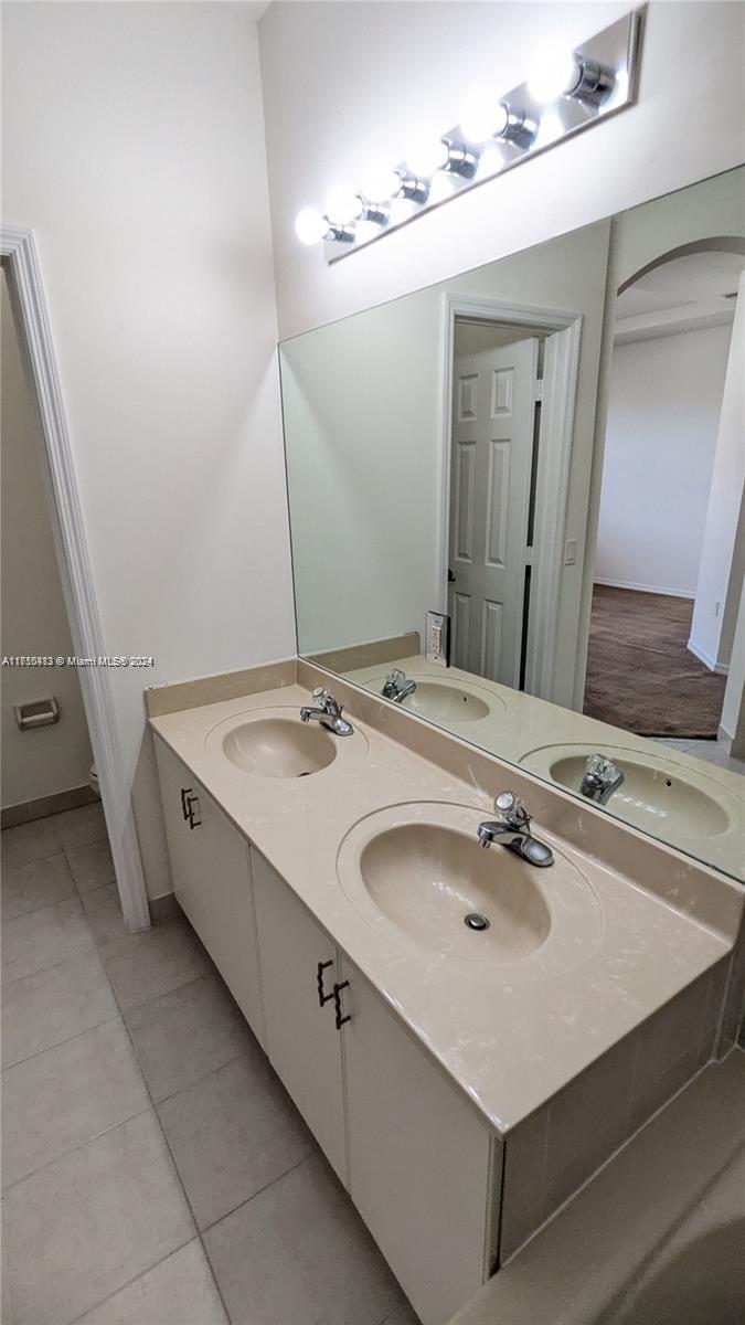 11840 Southwest 154th Avenue, Unit 11840 Miami, FL 33196 - Photo 54 of 61 a bathroom with a sink and a mirror