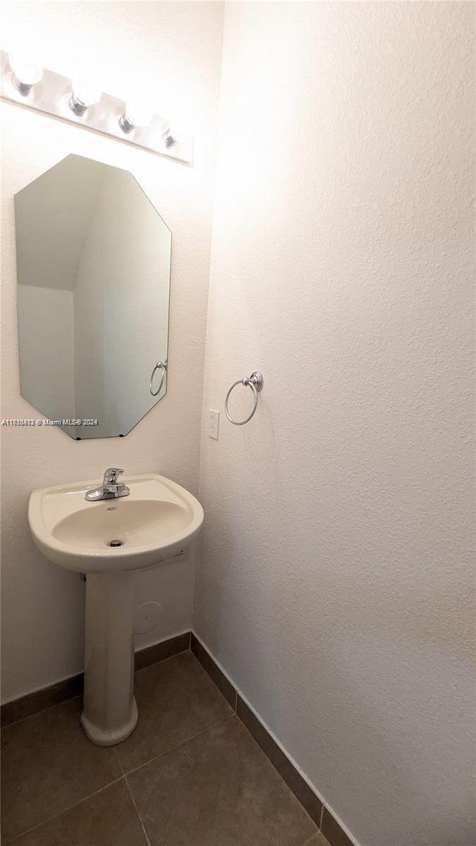 11840 Southwest 154th Avenue, Unit 11840 Miami, FL 33196 - Photo 10 of 61 a bathroom with a sink and mirror