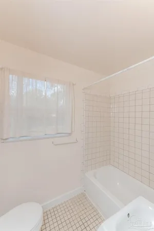 a bathroom with a bathtub and a toilet