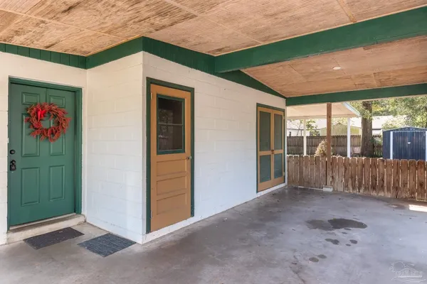 a view of a porch with furniture and floor to ceiling window