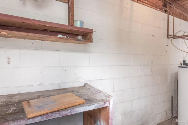 a bathroom with a granite countertop sink and white cabinets
