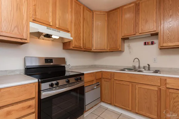 a kitchen with stainless steel appliances granite countertop a sink stove and cabinets