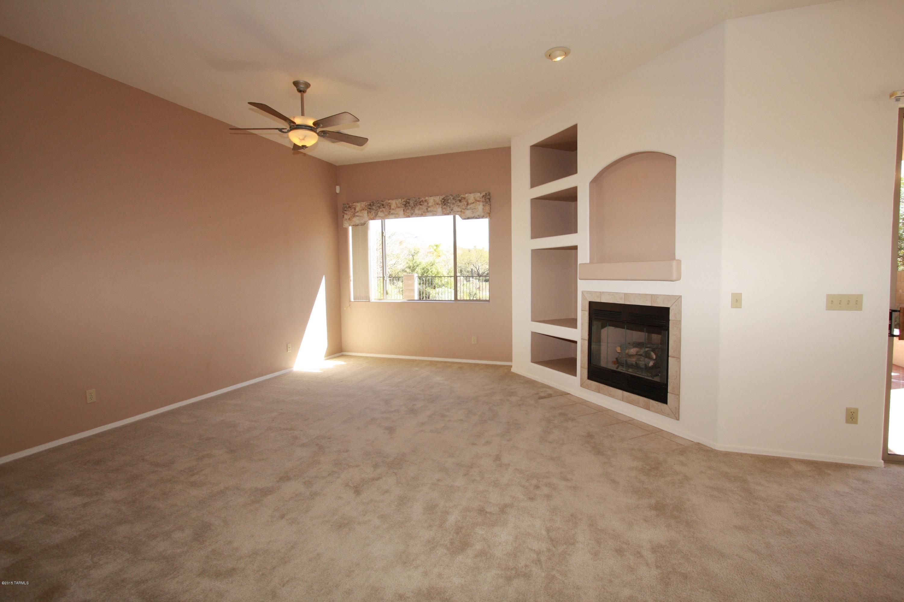 5206 North Canyon Rise Place Tucson, AZ 85749 - Photo 5 of 23 Living room w/FP, ceiling fan & mtn view