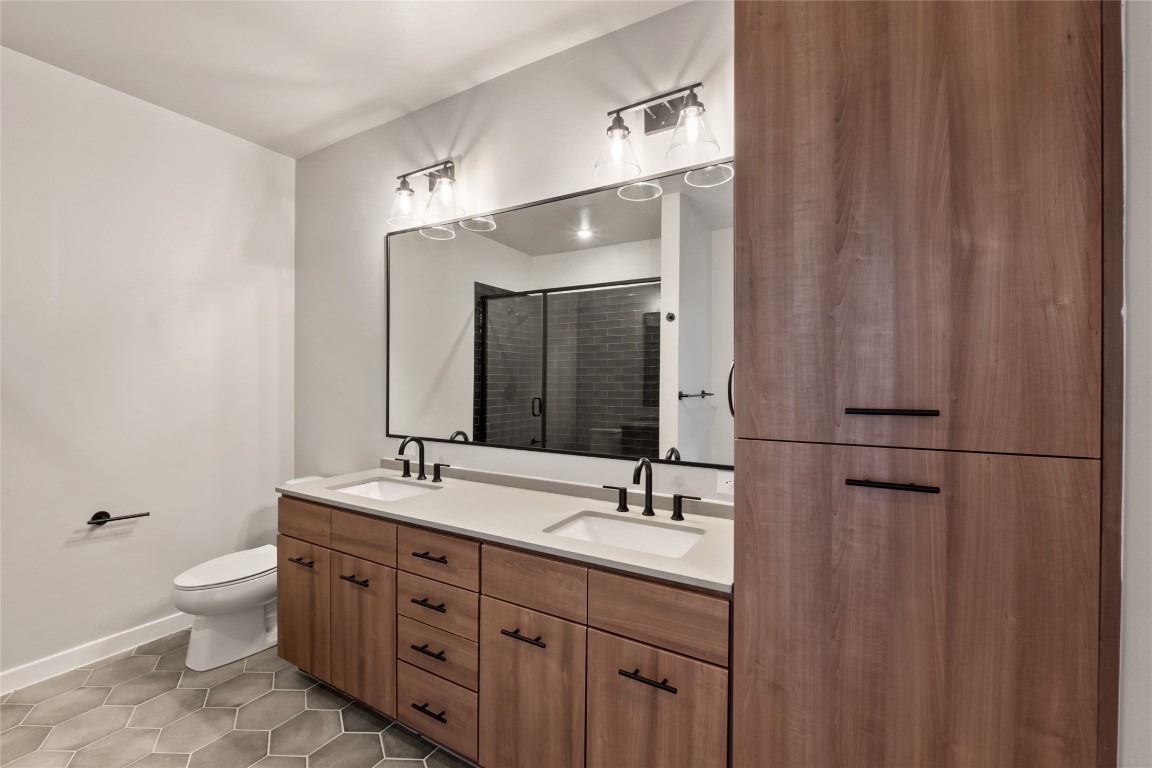 4510 Terry-O Lane, Unit 322 Austin, TX 78745 - Photo 15 of 35 a bathroom with double vanity sink a mirror and a shower
