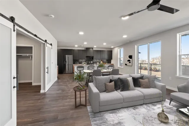 a living room with furniture and kitchen view