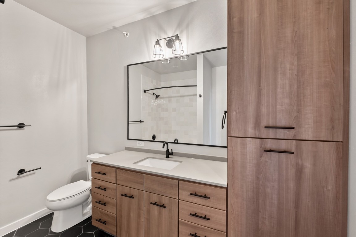 4510 Terry-O Lane, Unit 322 Austin, TX 78745 - Photo 22 of 35 a bathroom with a toilet a sink and a mirror