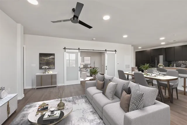 a living room with furniture and a wooden floor