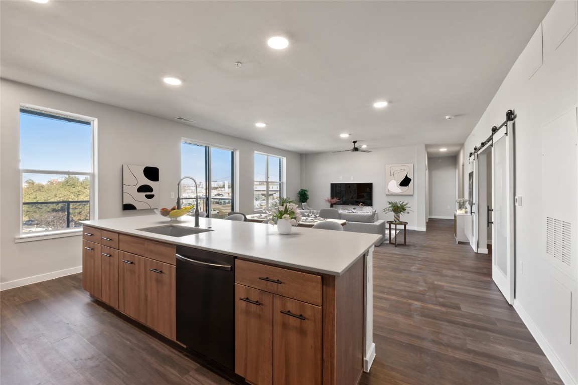4510 Terry-O Lane, Unit 322 Austin, TX 78745 - Photo 35 of 35 a large kitchen with stainless steel appliances a sink dishwasher stove and wooden floor