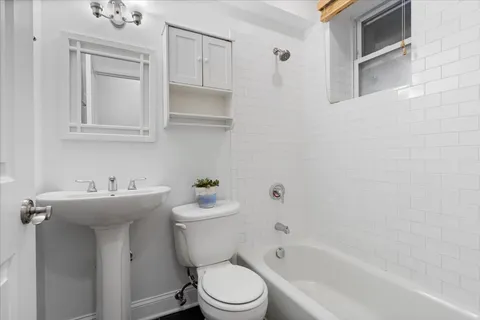 a bathroom with a sink a toilet and bathtub