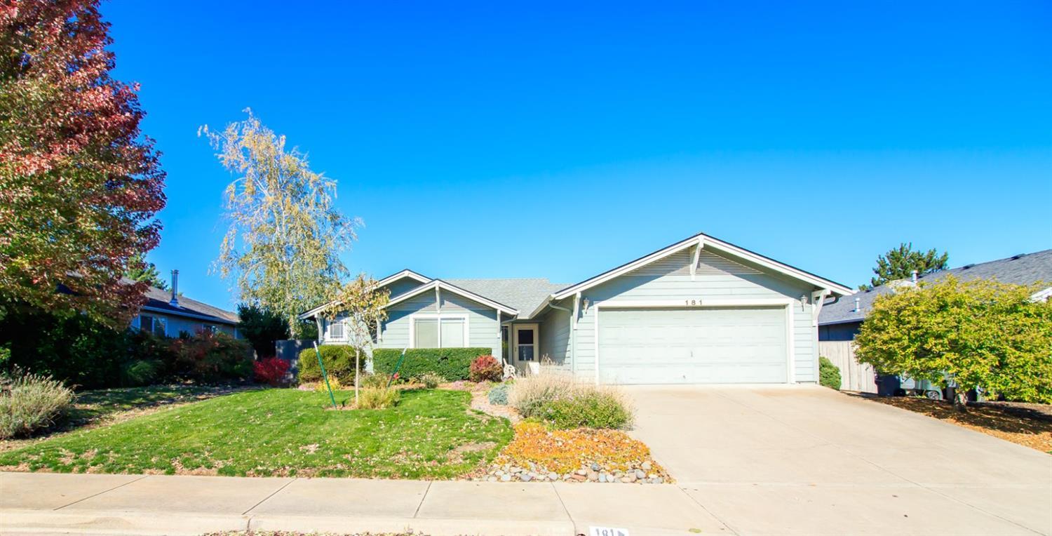 181 Autumn Ridge Road Talent, OR 97540 - Photo 1 of 25 a front view of a house with a yard and garage