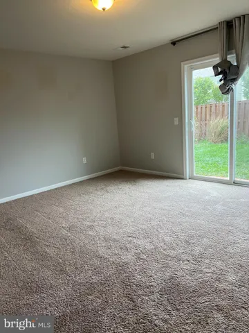 a view of an empty room with a sliding door