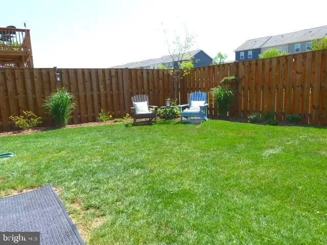 a view of a backyard with sitting area