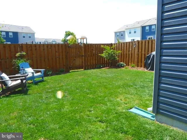 a view of a backyard with sitting area