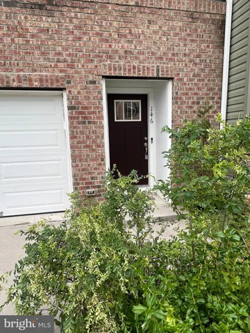 a front view of a house with plants