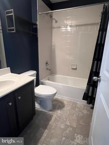 a bathroom with a sink a toilet and a shower