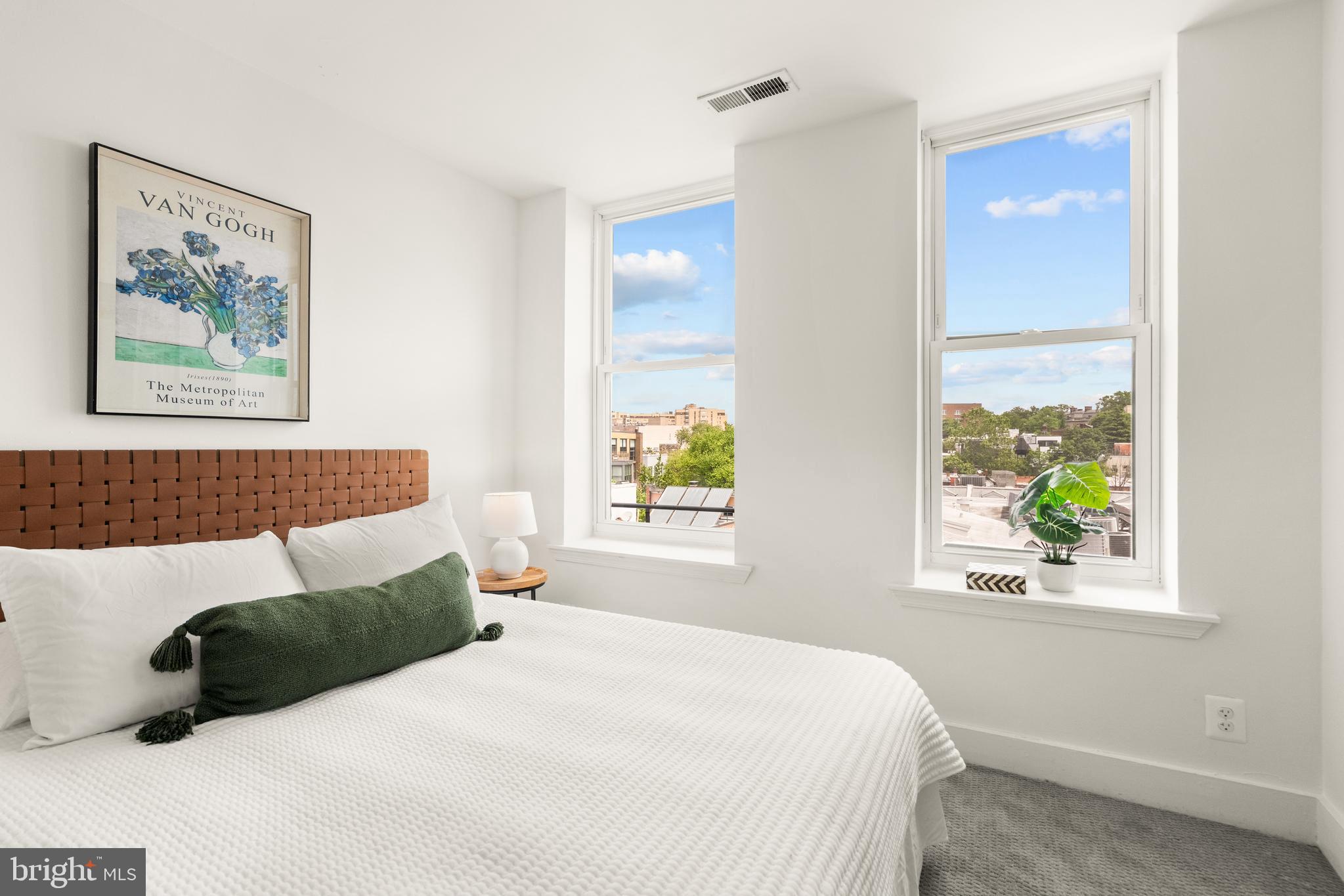 2305 18th Street Northwest, Unit 406 Washington, DC 20009 - Photo 11 of 28 a bedroom with a bed and a painting on the wall