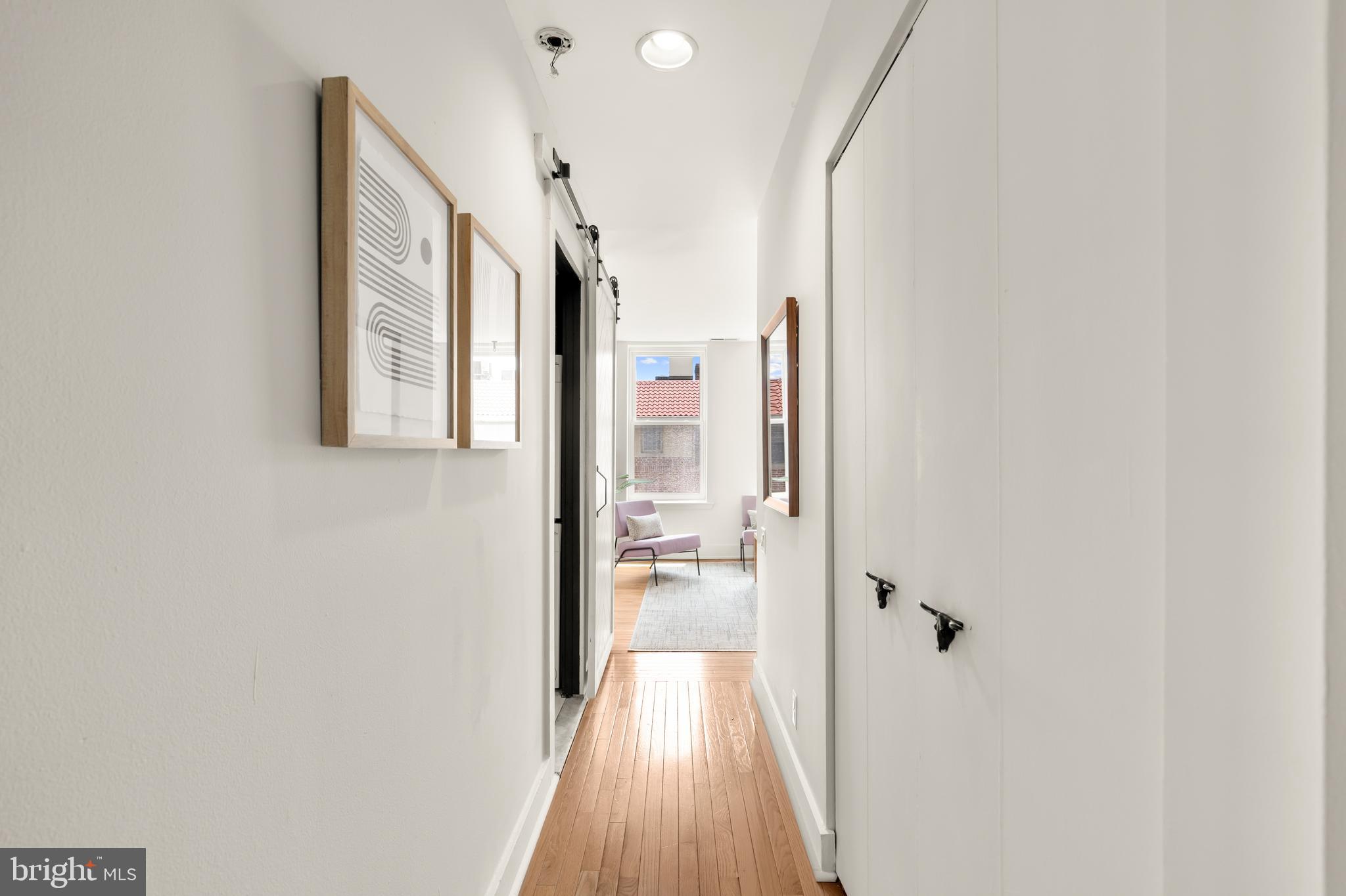 2305 18th Street Northwest, Unit 406 Washington, DC 20009 - Photo 12 of 28 a view of a hallway with wooden floor and staircase
