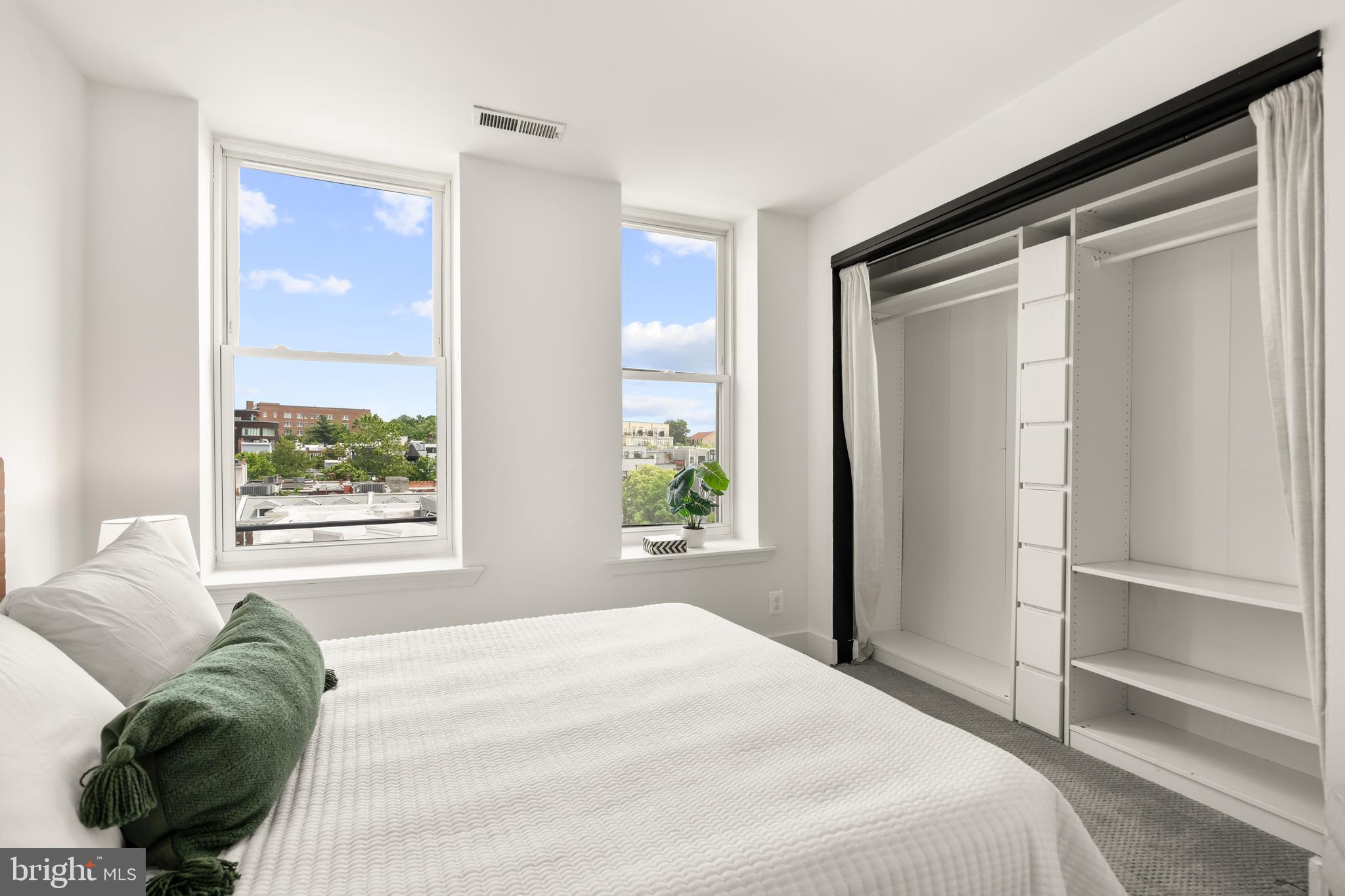 2305 18th Street Northwest, Unit 406 Washington, DC 20009 - Photo 10 of 28 a bedroom with a bed and a window