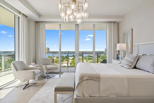 a bedroom with bed and large windows