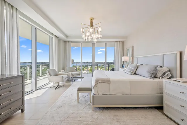 a bedroom with a large bed and a flat tv screen on dresser