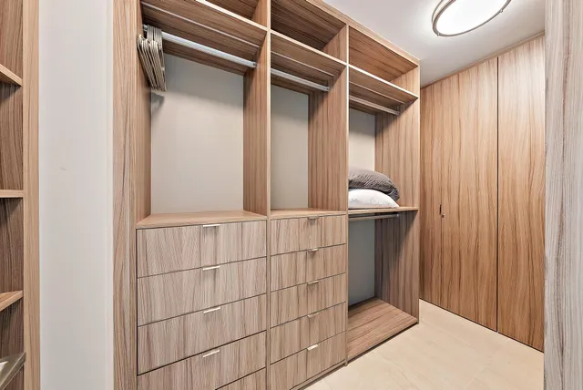 a large white bathroom with a large tub sink vanity and mirror