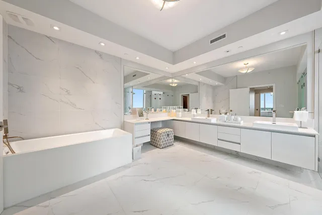 a large bathroom with a double vanity sink shower and a mirror