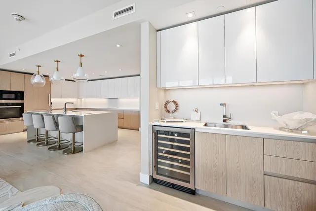 a kitchen with a sink and chairs