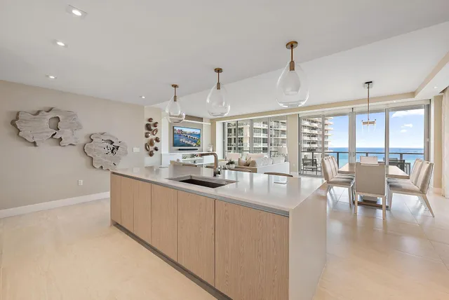 a kitchen with counter top space and living room