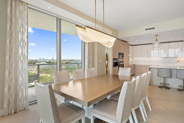 a dining room with furniture a chandelier and wooden floor