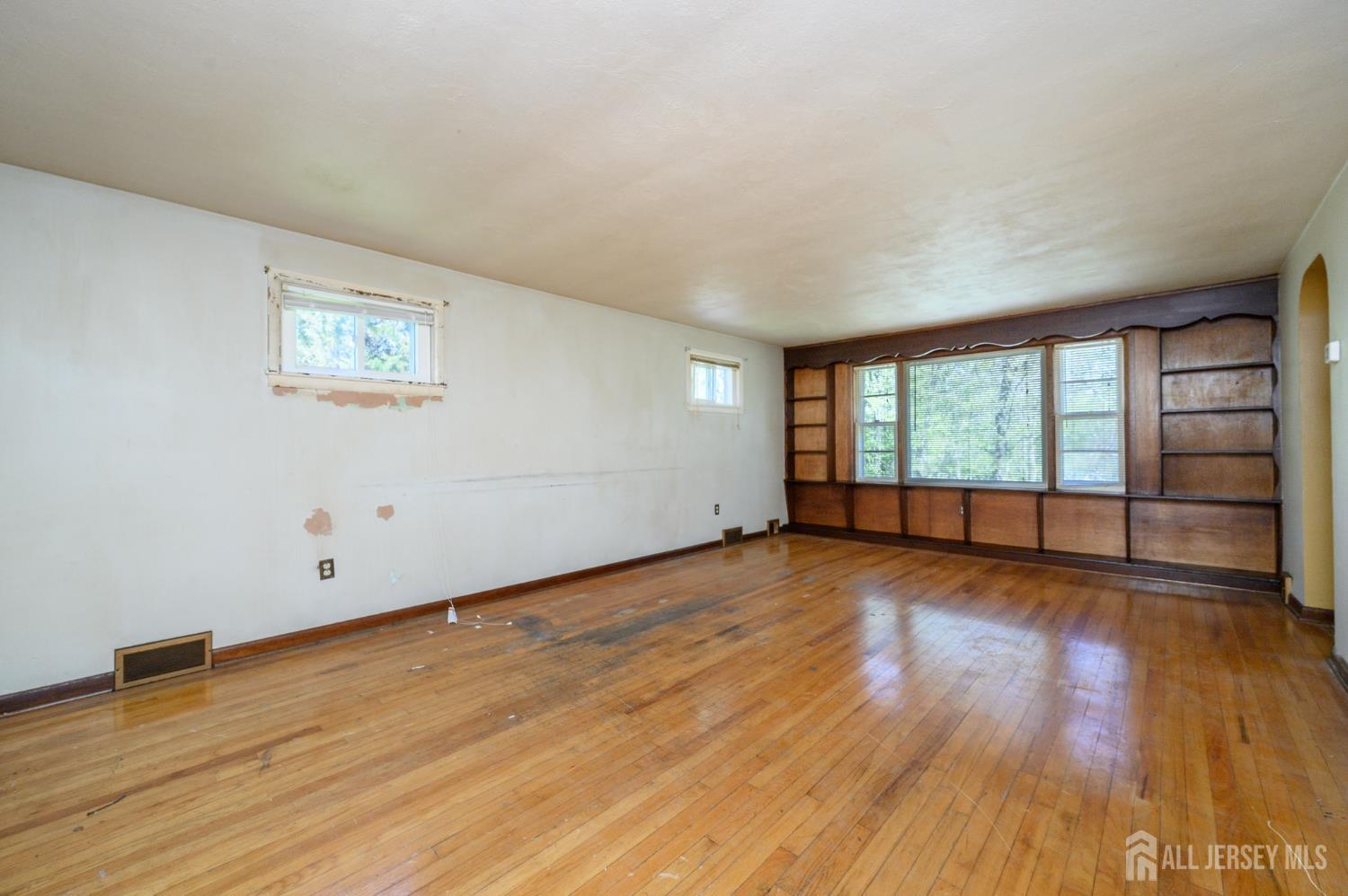 784 Yardville Hamilton Square Road Hamilton, NJ 08691 - Photo 13 of 47 a view of an empty room with wooden floor and a window