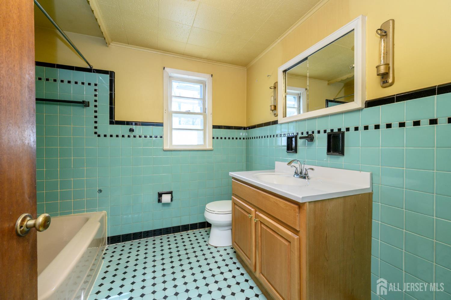 784 Yardville Hamilton Square Road Hamilton, NJ 08691 - Photo 17 of 47 a bathroom with a sink a toilet and mirror