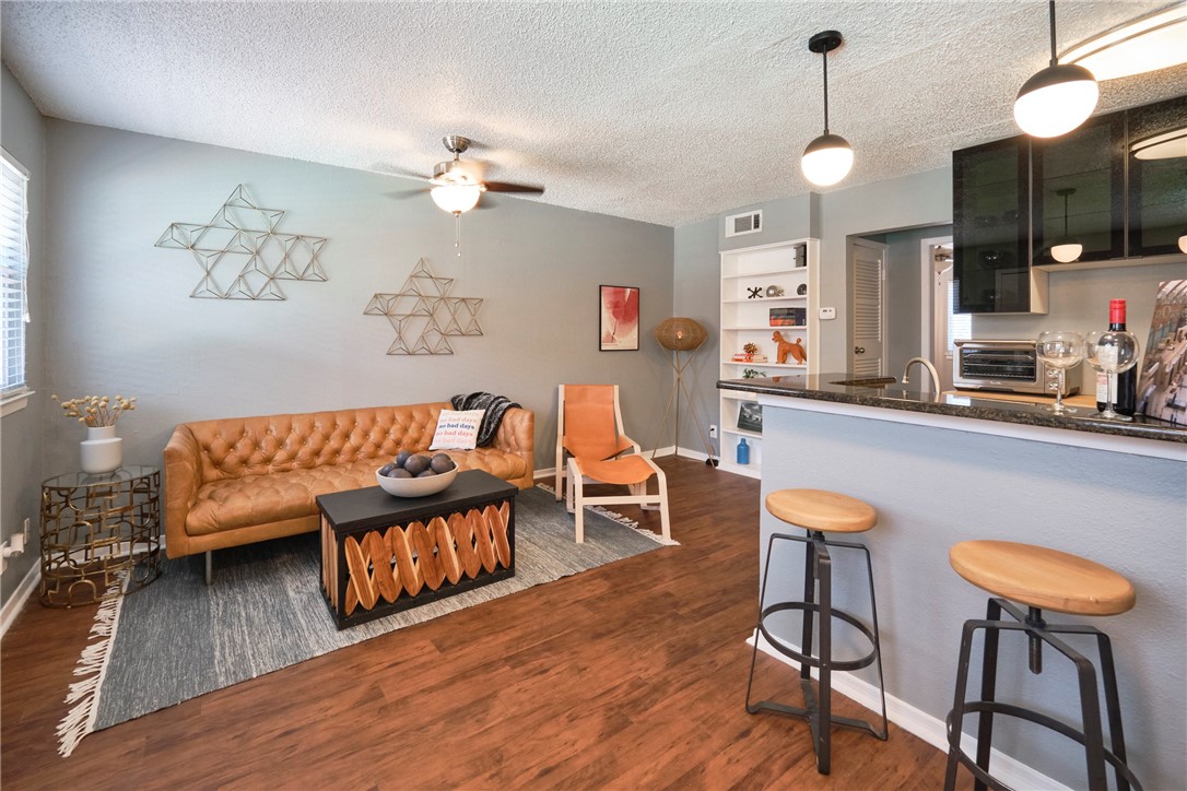 a living room with furniture and a wooden floor