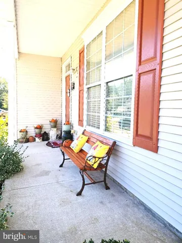 a view of a dining room with furniture and a chandelier