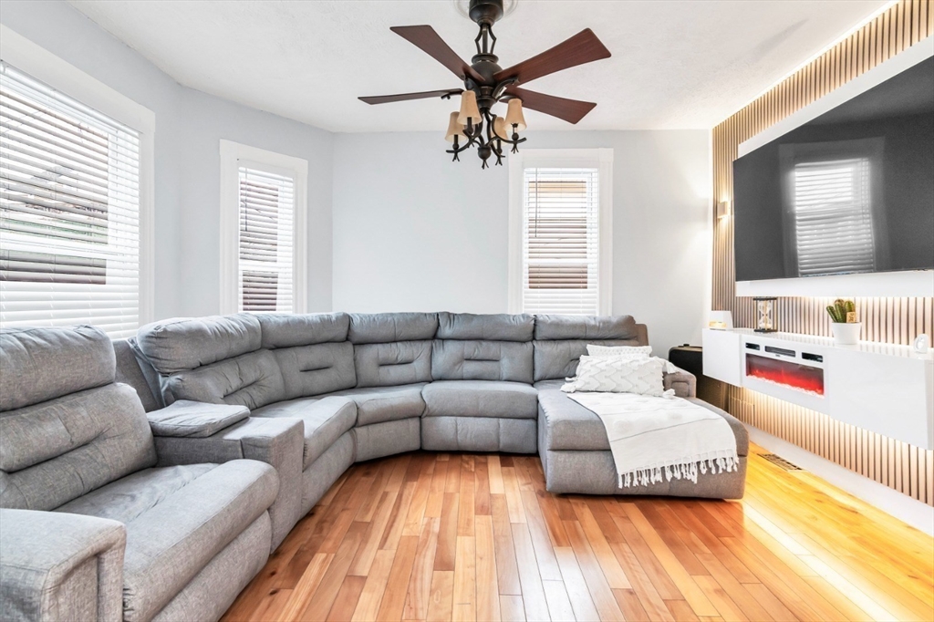 42 D Street Lowell, MA 01851 - Photo 9 of 27 a living room with furniture ceiling fan and a window