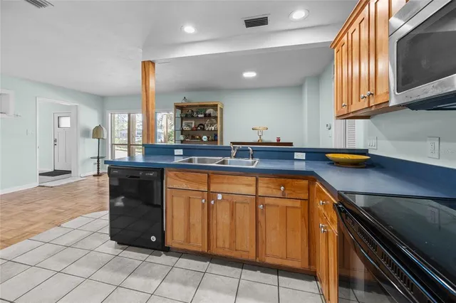 a kitchen with stainless steel appliances granite countertop a sink and a stove