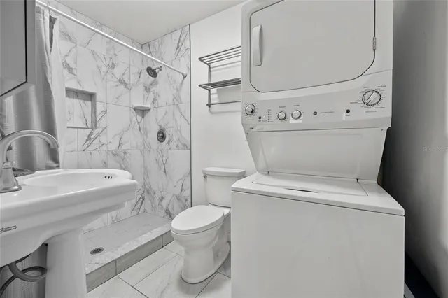 a white toilet sitting next to a bathroom sink