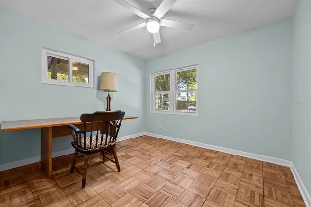 a workspace with wooden floor and a window