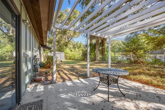 a patio with glass top table and chairs