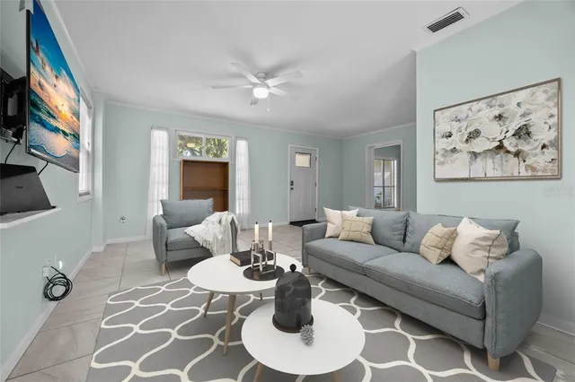 a living room with furniture a rug and a painting