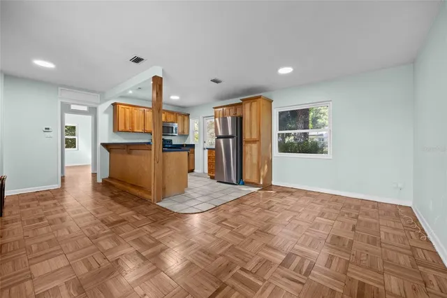 a view of kitchen with furniture and refrigerator