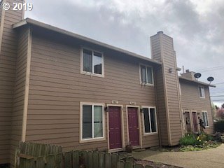 9733 Southeast Foster Road Portland, OR 97266 - Photo 2 of 16 a brick house with a small yard and a large window