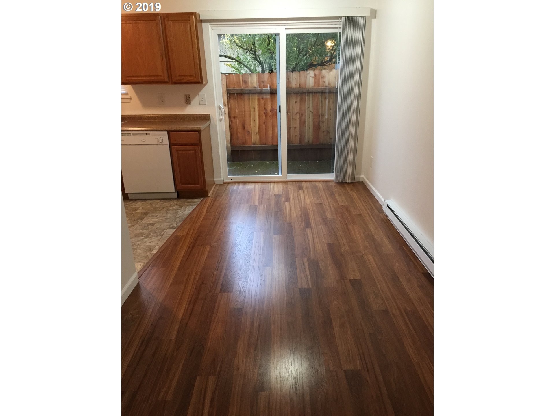 9733 Southeast Foster Road Portland, OR 97266 - Photo 6 of 16 a view of a kitchen with wooden floor and a window